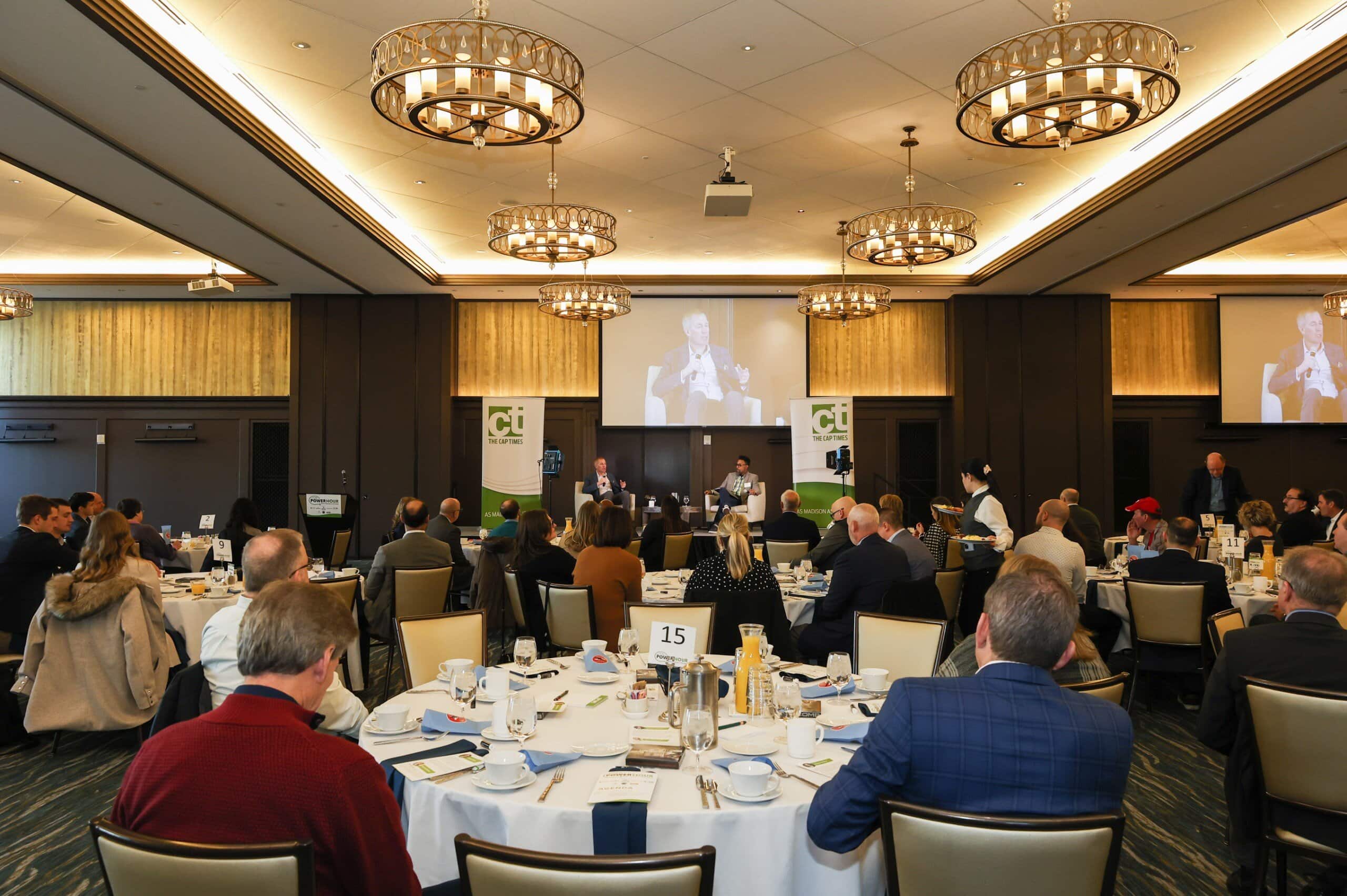 _e0a1883 Business conference with seated attendees and speakers.